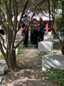 People in costume visiting the cemetery