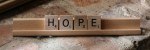 Letters in Scrabble rack spelling the word HOPE